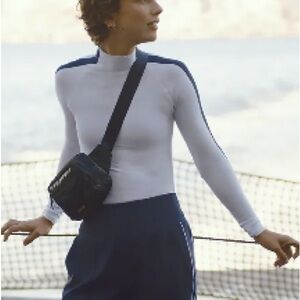 Athleta Rewnew Seamless Mock neck size: small
SOLD OUT black stripe down arm